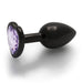 Small gunmetal metal butt plug with a heart-shaped amethyst-colored jewel base, smooth and tapered design.
