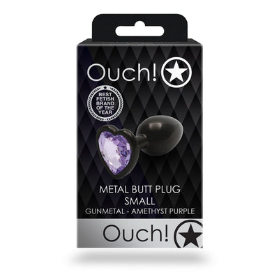 Small gunmetal metal butt plug with amethyst purple heart-shaped jewel in black and silver packaging.