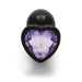 Small gunmetal metal plug with a heart-shaped amethyst-colored gem base, smooth and tapered for comfortable use.