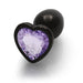 Small gunmetal metal butt plug with a heart-shaped amethyst-colored jewel base, smooth and tapered design.
