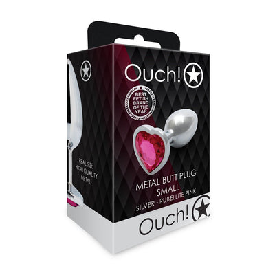 Packaging of a small silver metal butt plug with a pink heart-shaped jewel base from Ouch! brand.