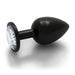 Large black metal butt plug with a clear round gem base, smooth tapered design for comfortable use.