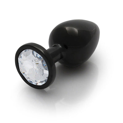 Large black metal butt plug with a clear round gem base, smooth tapered design for comfortable use.