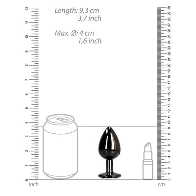 Large sleek black metal butt plug with a round jewel base shown next to size comparison graphics and rulers.