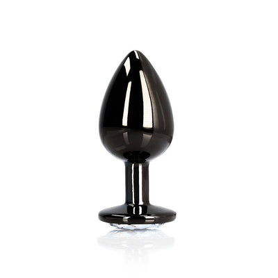 Large sleek black metal butt plug with a tapered tip and a clear round gem at the flared base.