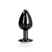 Large sleek black metal butt plug with a tapered tip and a clear round gem at the flared base.