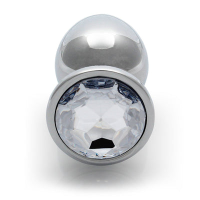 Large smooth metal butt plug with a clear faceted gem base, designed for comfortable and stylish wear.