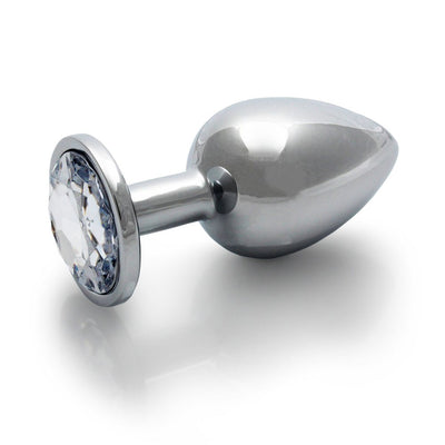 Large smooth metal butt plug with a clear round gem base, polished silver finish, and tapered tip for easy insertion.