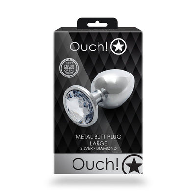 Packaging of Shots Ouch! large silver metal butt plug with a clear diamond-shaped jewel on the base.