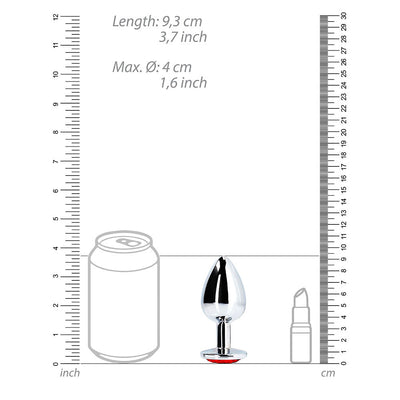 Large silver metal butt plug with a round red gem base shown next to a soda can and lipstick for size comparison.