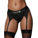 Black vibrating strap-on thong with adjustable garters worn with sheer thigh-high stockings on model.