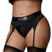 Close-up of a model wearing a black vibrating strap-on thong with adjustable garters and Ouch! branded waistband.