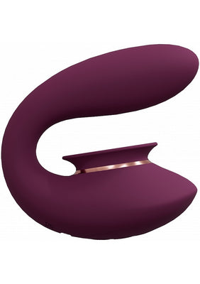 Sleek purple silicone rechargeable vibrator with curved design and suction feature for targeted stimulation.