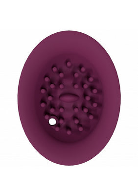 Top view of a deep purple silicone attachment with textured nodules and a small circular opening.