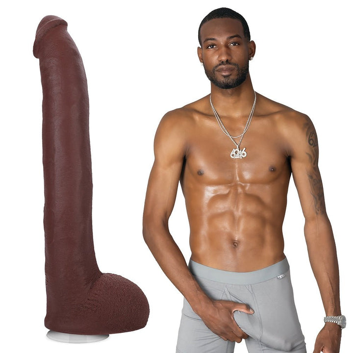 Dark brown realistic 11-inch dildo with textured veins and testicles next to a shirtless man in gray shorts.