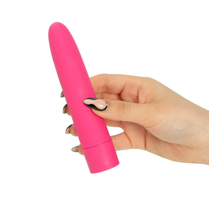 Hand holding a compact pink bullet vibrator with smooth, rounded tip and matte finish.