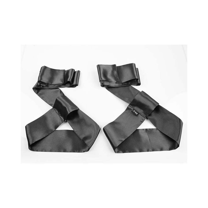 Black satin silky restraints laid flat on a white background from the S&M Shadow Secrets Kit.