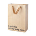 Kraft paper gift bag with brown ribbon handles and black text reading I got this on my way here, 11 x 8 x 4 inches.