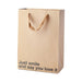 Kraft paper gift bag with brown ribbon handles and "Just smile and say you love it" printed in black text.