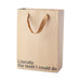 Kraft paper gift bag with brown ribbon handles and the phrase literally the least I could do printed on the front.
