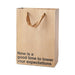 Brown kraft gift bag with brown ribbon handles and black text reading now is a good time to lower your expectations
