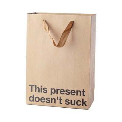 Kraft gift bag with brown ribbon handles and bold black text reading This present doesn't suck.