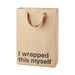 Kraft paper gift bag with brown ribbon handles and bold black text reading I wrapped this myself.