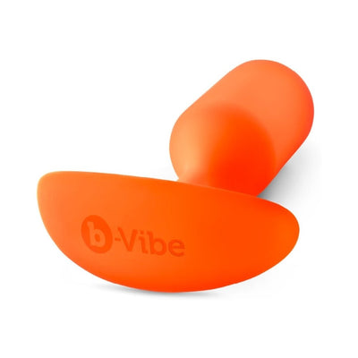 Orange b-Vibe Weighted Snug Plug 3 made of smooth silicone with a curved base and ergonomic design.