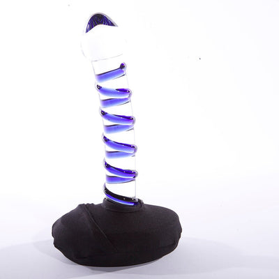 Black large base stabilizer supporting a clear glass dildo with blue spiral design on a white background.