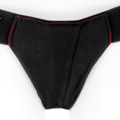 Black and red nylon double-strap Joque Cover underwear harness with textured fabric and adjustable waistband.
