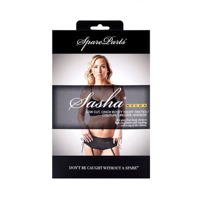 Packaging of SpareParts Sasha Cinch Booty Short Harness in black with model wearing the adjustable lingerie piece.