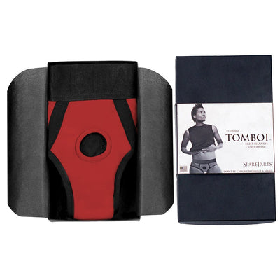 Red and black Spareparts Tomboi nylon briefs harness displayed in black packaging with product label and photo.
