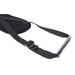 Close-up of black adjustable strap with padded oval section and clear plastic grip handle on white background.