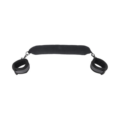 Black padded flexible positioning bar with attached adjustable cuffs on each end for support and restraint.