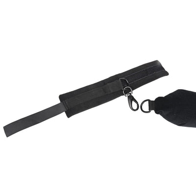 Black padded flexible positioning bar with attached cuffs and metal clip connectors on white background.