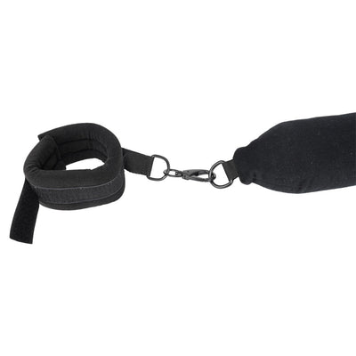 Black padded flexible positioning bar with attached soft cuff and metal clip on white background