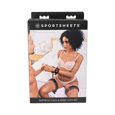 Packaging of Sportsheets Saffron Adjustable Thigh and Wrist Cuff Set featuring a couple using the restraints in a bedroom setting.