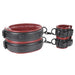 Adjustable black and red padded faux leather thigh and wrist cuffs connected with metal clips for versatile restraint options.