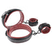 Adjustable black and red padded thigh and wrist cuffs with buckles and clips for secure restraint.