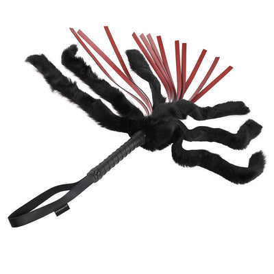 Black faux fur and red faux leather flogger with woven handle and wrist strap for grip and control.