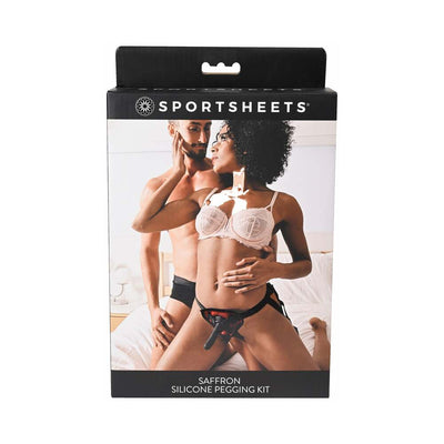 Packaging of Sportsheets Saffron Silicone Pegging Kit featuring a couple with the adjustable strap-on harness and dildo.