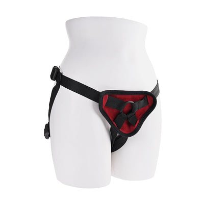 Adjustable black strap-on harness with red padded front panel displayed on white mannequin hips