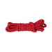 Red cotton rope neatly coiled, designed for comfortable and versatile restraint use.