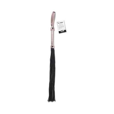 Sportsheets Sex & Mischief Brat Flogger with rose gold handle and black faux leather falls, featuring a wrist loop and attached tag.