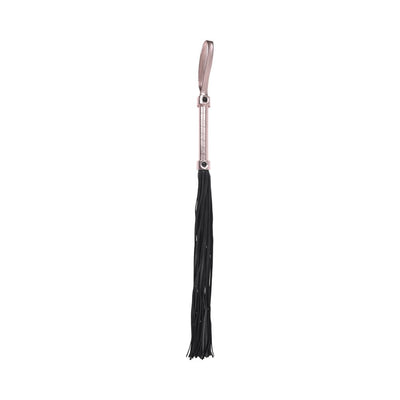 Black faux leather flogger with rose gold handle and wrist loop, featuring multiple soft falls for playful sensation.