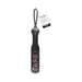 Black faux leather paddle with wrist loop and the word BRAT embossed on the striking surface, featuring a product tag.