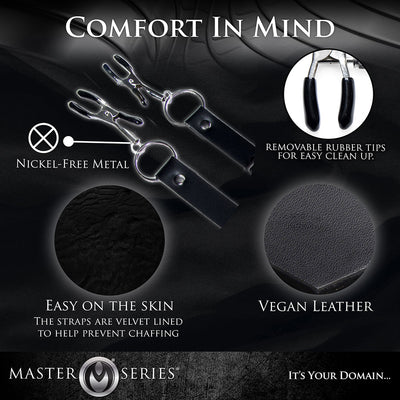 Black vegan leather labia spreader straps with nickel-free metal clamps and removable rubber tips, velvet lined for comfort.