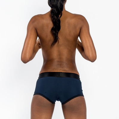 Back view of a person wearing a navy and black EmEx Fit Harness in size XS with a sleek, comfortable design.
