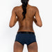 Back view of a person wearing a navy and black EmEx Fit Harness in size XS with a sleek, comfortable design.