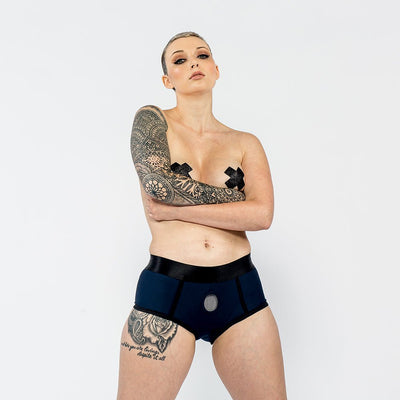 Model wearing a black EmEx Fit Harness-XS with a nitrile O-ring and elastic waistband against a white background.